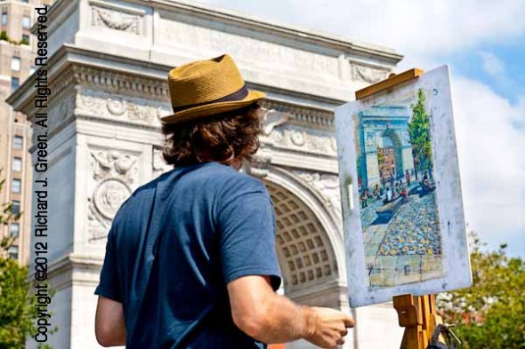 An artist works on his painting in Washington Square Park in Man
